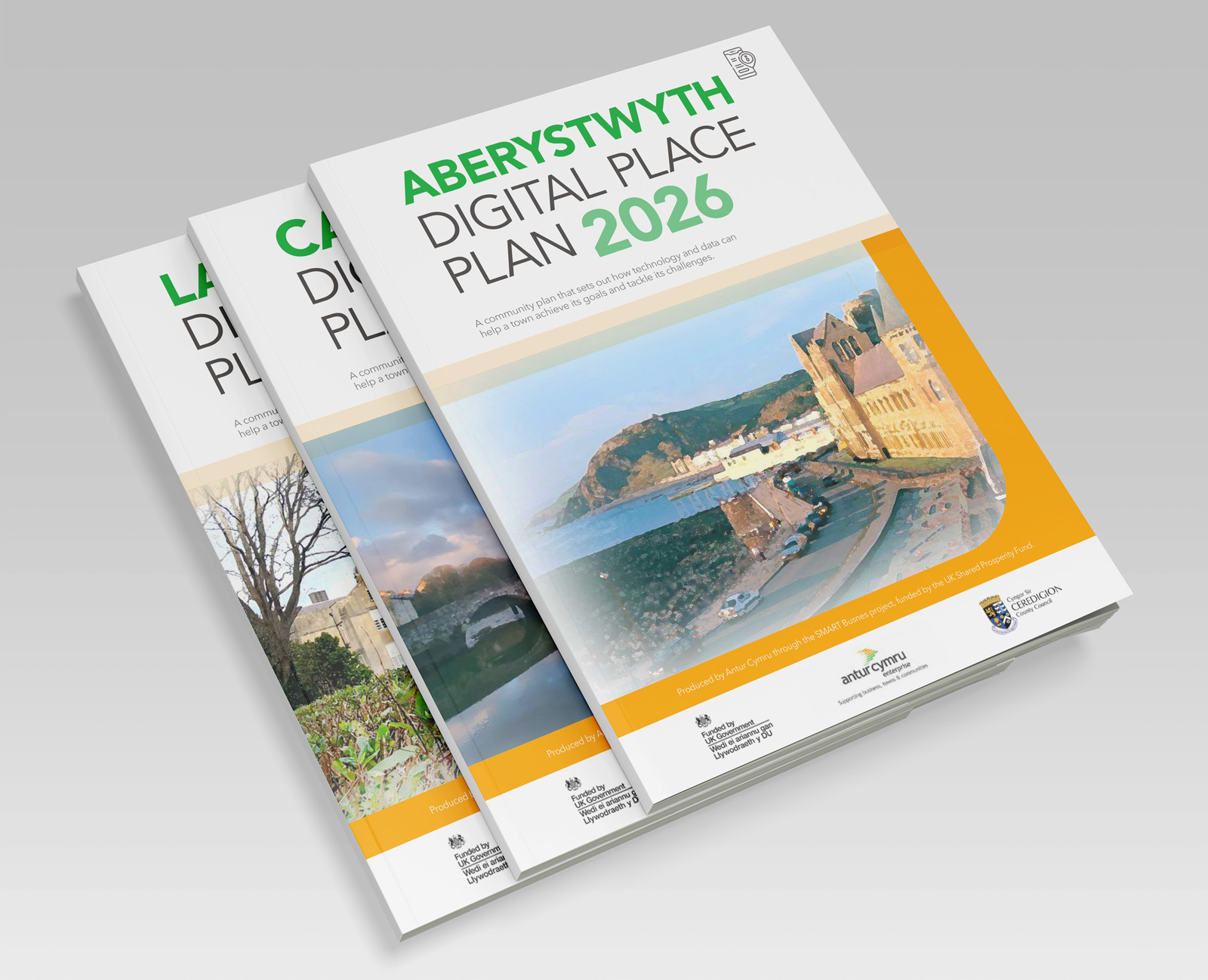 Three Digital Place Plan brochures for Aberystwyth, Cardigan and Lampeter stacked, each with a watercolour cover illustration
